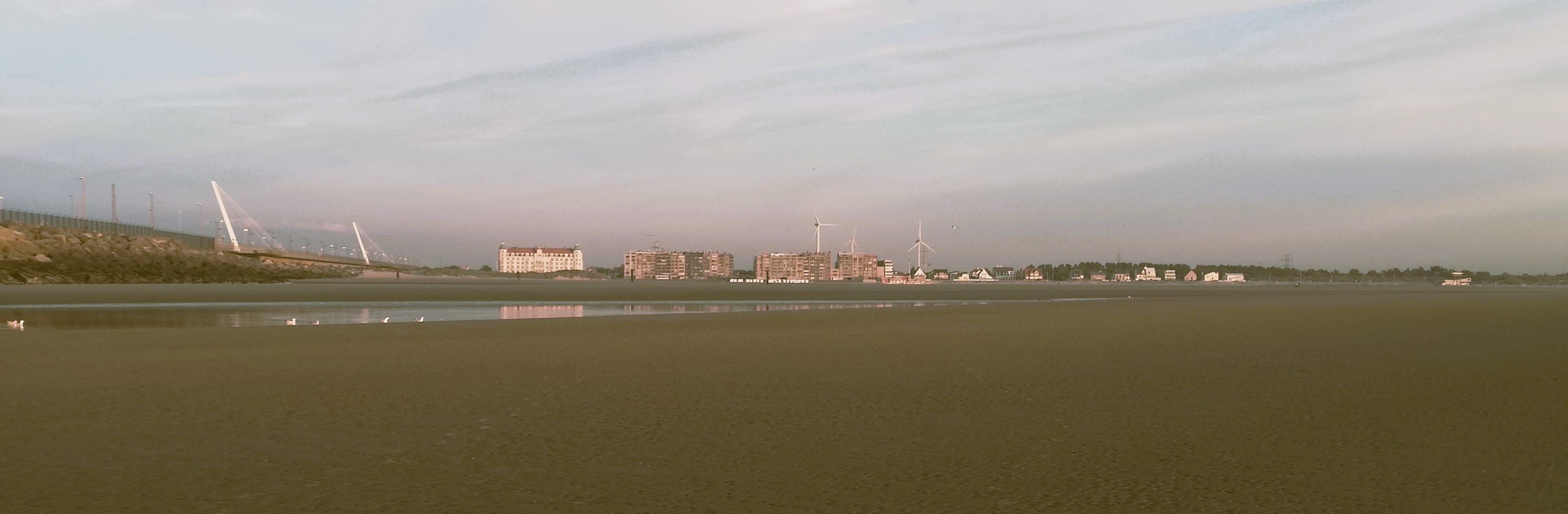 The wide Zeebrugge beach and distant waterline at low tide